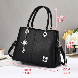 Black lychee leather tote bag for women with silver pendant and detachable shoulder strap