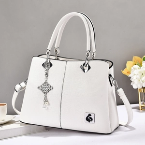 White litchi pattern tote bag with silver tassel and adjustable shoulder strap