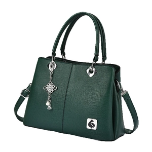 Deep green lychee textured handbag with pearl charm and adjustable shoulder strap