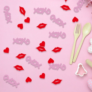XOXO letters, red lips and heart confetti pieces for Valentines Day party table decor