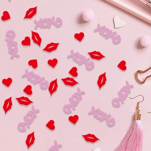 Red heart and lip shaped confetti with pink XOXO letters for Valentine's table decor