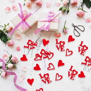 Red heart and LOVE confetti for Valentine wedding party table decoration on marble