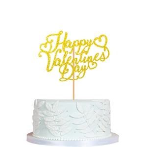 Macro shot of gold glitter Happy Valentine's Day cake topper with heart symbols on white cake