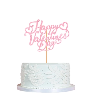 Pink glitter Happy Valentine's Day cake topper with hearts on a blue floral cake