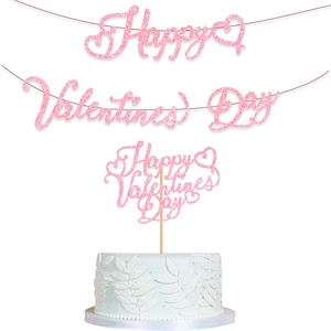 Close-up of pink glittery Happy Valentine's Day banner and cake topper party decorations