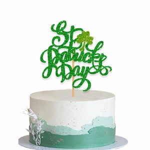 Glittery green St. Patrick's Day cake topper with clover design on a cream cake