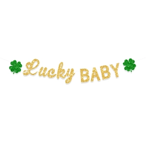 Close-up of Lucky BABY banner with green glitter shamrocks for St. Patrick's Day party