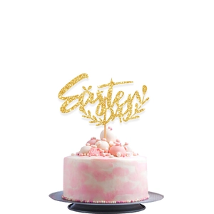 Close-up of golden glitter Easter DAY cake topper on a pink marble frosted cake