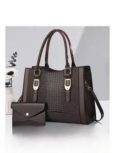 Detail view of coffee brown tote bag set with crocodile texture and matching clutch