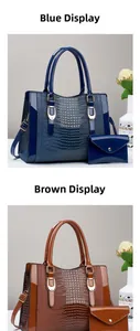 Detail of glossy crocodile embossed faux leather tote bag and clutch set with gold hardware