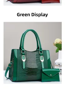 Detail of green patent leather tote with crocodile texture and matching clutch set