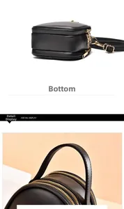 Vue détaillée du mini sac à main noir avec doubles fermetures éclair dorées et poignée