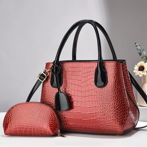 Detail of red croc-embossed patent leather tote and matching zipper coin purse set