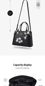 Detail view of large capacity black tote with floral embroidery and interior pockets