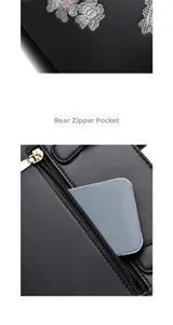 Detailed view of the back zipper pocket and floral embroidery on black leather tote