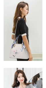 Detail of floral butterfly embroidery and silk scarf on grey high-capacity tote bag