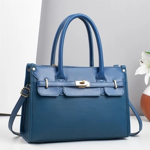 Navy blue leather tote bag with gold lock closure and top handle for women