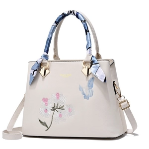 White leather handbag with floral butterfly embroidery and blue silk scarf decoration