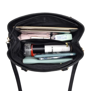 Large black leather tote bag showing spacious interior with tablet and daily essentials