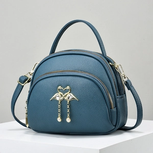 Dark blue multi-zipper handbag with flamingo heart buckle and pearl charms on white block