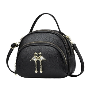 Black lychee texture crossbody bag with gold flamingo heart and pearl pendant detail