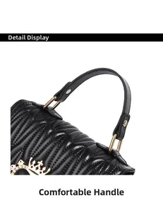 Close-up of the elegant black quilted leather texture and golden crown-shaped buckle