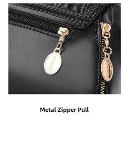 Detail of black woven leather handbag showing golden hardware zipper pull with logo