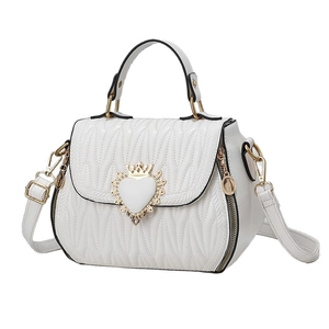 White quilted crossbody bag with golden crown heart clasp shown in a front-side view
