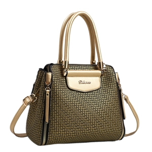 Luxurious gold textured handbag with geometric pattern and metal plate on white background