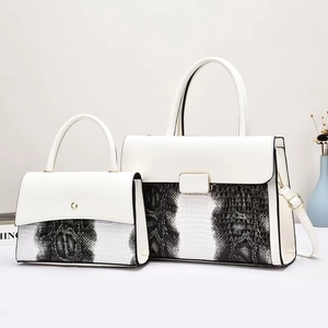 Modern white leather handbag set with black and white snakeskin pattern and gold hardware