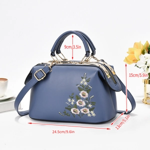 Detail view of floral embroidered bag with dimensions: 24.5cm length and 15cm height