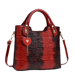 Elegant red crocodile texture leather handbag with heart charm and golden hardware