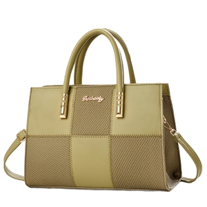 Olive green and khaki patchwork tote bag with woven texture and gold metal hardware