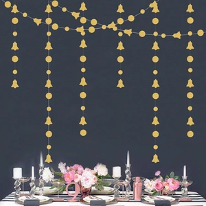 Close-up of gold glitter Christmas garland with bells and disks for party decoration