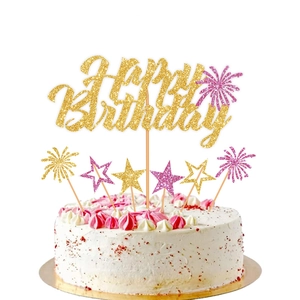 Macro detail of Happy Birthday cake toppers with gold and pink glitter finish for parties