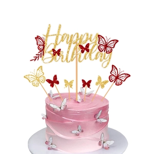 Close-up of Happy Birthday cake topper with gold glitter and 3D butterfly decorations