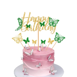 Macro shot of glittery Happy Birthday cake topper with assorted green and pink butterflies