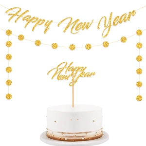 Close-up of glittery gold Happy New Year cake topper and matching hanging garlands set