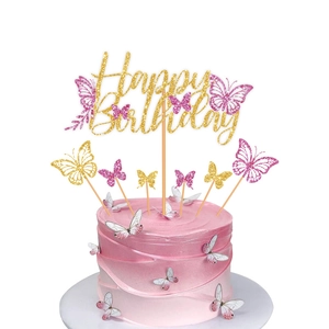 Golden Happy Birthday cake topper with pink glitter butterfly decorations on a cake