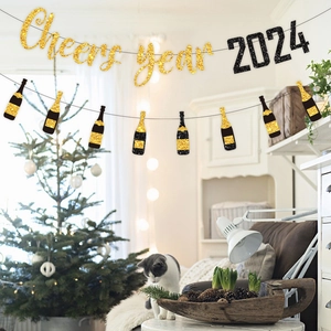 Close-up of gold and black glitter 2024 New Year banner with champagne bottle charms