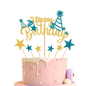 Detail of glitter Happy Birthday topper and star picks on a pink cream cake