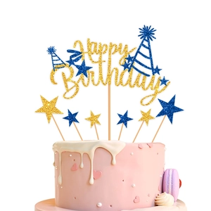 Detailed view of glittering Happy Birthday cake topper with gold stars on a pink cake