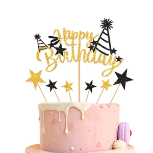Golden glitter Happy Birthday cake topper set with black and gold stars on pink cake