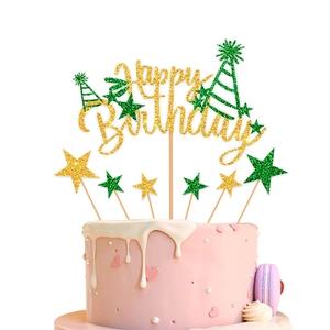 Close-up of glittery gold Happy Birthday cake topper set with stars and party hats