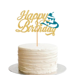 Close-up of golden glitter Happy Birthday cake topper with teal accents on white cake