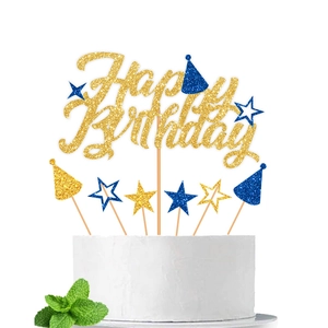 Dettaglio di cake topper Happy Birthday glitterati blu e oro con stelle e cappellini