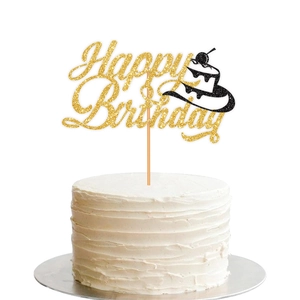 Golden glitter Happy Birthday cake topper with a black cowboy hat on a white cake