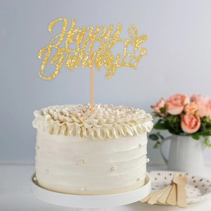 Golden glitter Happy Birthday cake topper with gift box design on a white cream cake
