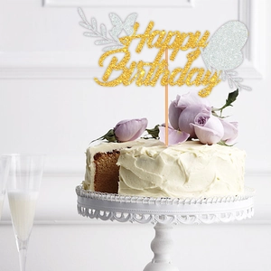 Golden glitter Happy Birthday cake topper with silver butterflies on a white cream cake