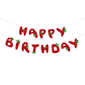 Detail of red glitter Happy Birthday banner with strawberry leaf accents for party decor